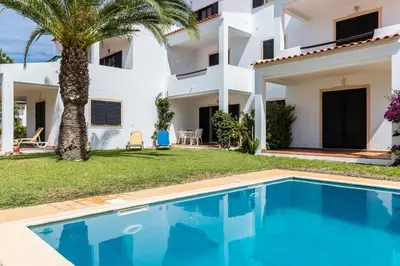a villa with a swimming pool in front of a house at Akisol Olhos de Agua Pine II in Albufeira