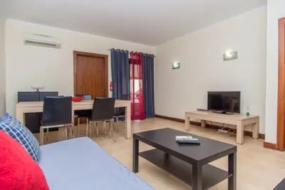 a living room with a couch and a table at Akisol Albufeira Guia II in Guia