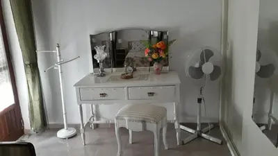 a white dressing table with a mirror and a stool at Vivenda João Damas in Albufeira