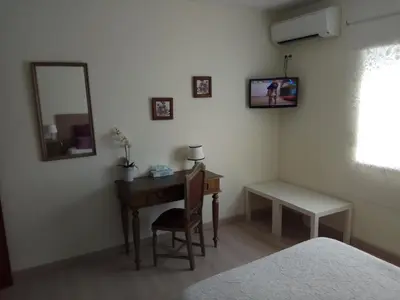 a bedroom with a desk and a mirror and a bed at Apartamento de Praia - Albufeira in Albufeira