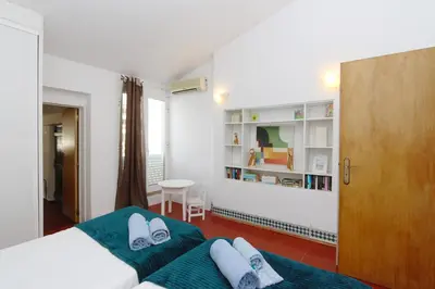a bedroom with two beds and a table in it at Villa Molgard 61 - Clever Details in Vilamoura