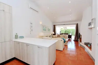 a kitchen and living room with a couch at Villa Molgard 61 - Clever Details in Vilamoura