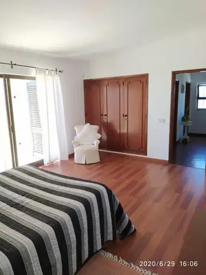 a bedroom with a bed and a wooden floor at Villa Paraiso - 4 Bedrooms and pool in Albufeira