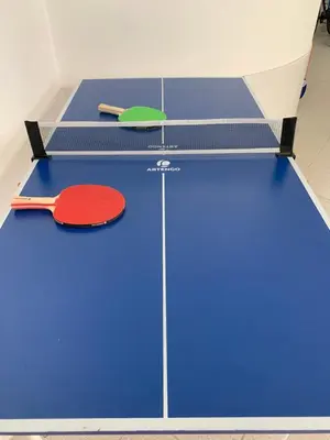 a ping pong table with a tennis racket on it at Algarvila in Vilamoura