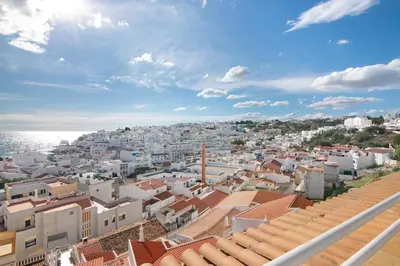a view of a city with white buildings and the ocean at Apartamento Varandas do Mar, Praia dos Pescadores, Albufeira in Albufeira
