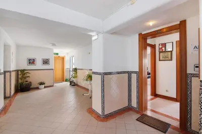 a hallway with white walls and a tile floor at Apartamento Varandas do Mar, Praia dos Pescadores, Albufeira in Albufeira