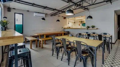 a dining room with wooden tables and chairs at Hostellicious in Faro