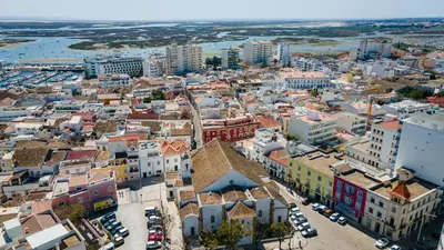 an aerial view of a city with buildings at Hostellicious in Faro