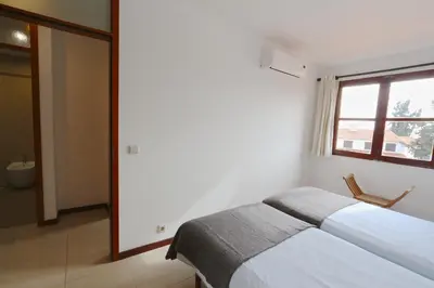 a white bedroom with a bed and a window at Vilar do Jardim 59 - Clever Details in Vilamoura