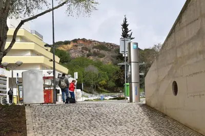 a group of people waiting at a gas station at Peneco II in Albufeira