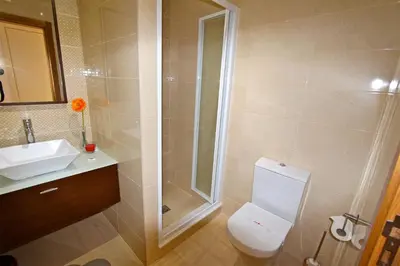 a bathroom with a shower and a toilet and a sink at Villa Violeta 51 - Clever Details in Vilamoura