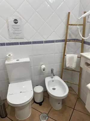 a bathroom with a toilet and a tub and a sink at Apartamentos Solar do Sol in Albufeira