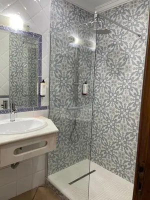 a bathroom with a sink and a toilet and a mirror at Apartamentos Solar do Sol in Albufeira