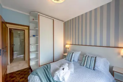 a bedroom with a bed with a towel on it at Blue Boat in Quarteira