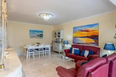 a living room with a red couch and a table at Blue Boat in Quarteira
