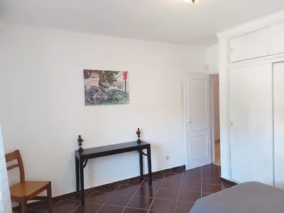a room with a table and a picture on the wall at The Pinewood Villa in Vilamoura