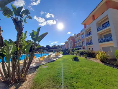 a view of a resort with a pool and palm trees at Blue House Corcovada in Albufeira