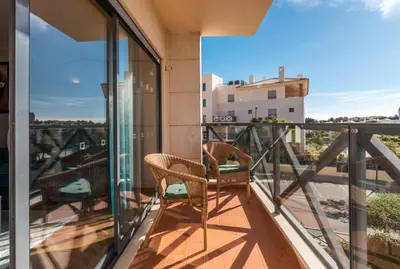 a balcony with two chairs and a view at Blue House Corcovada in Albufeira