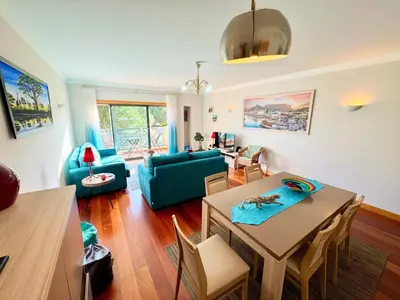 a living room with a table and a blue couch at Blue House Corcovada in Albufeira