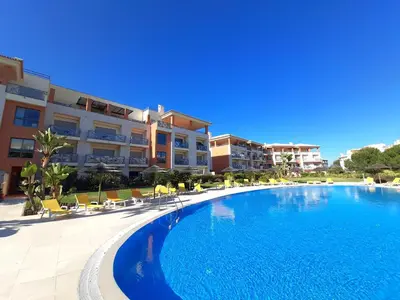 a large swimming pool in front of a building at Blue House Corcovada in Albufeira
