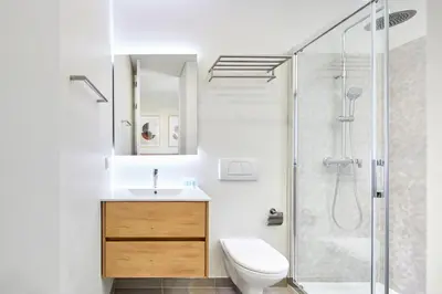 a white bathroom with a sink and a shower at Ancão Gardens in Quinta do Lago