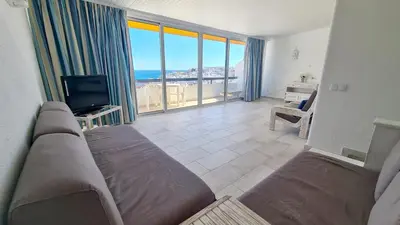 a living room with a couch and a television at Albufeira, vista mar (63) in Albufeira