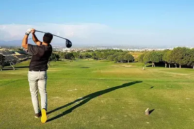 a man swinging a golf club on a golf course at Albufeira, vista mar (63) in Albufeira