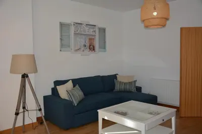 a living room with a blue couch and a table at Beautiful Apartment In Albufeira Marina in Albufeira