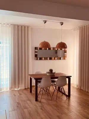 a dining room with a wooden table and chairs at Beautiful Apartment In Albufeira Marina in Albufeira