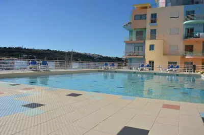 a large swimming pool in front of a building at Beautiful Apartment In Albufeira Marina in Albufeira