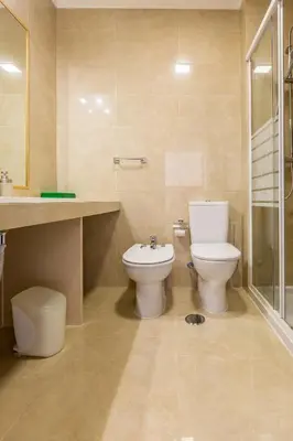 a bathroom with a toilet and a sink and a shower at Apartamento Correia in Albufeira