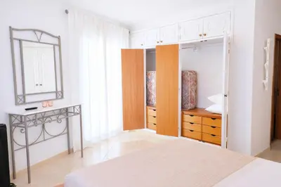 a bedroom with a bed with pineapple pillows and a lamp at Avenue Apartment in Quarteira