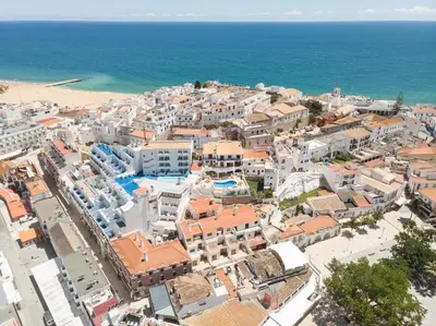 an aerial view of a city with buildings and the ocean at ETHOS Bertolina Wellness Urban Living in Albufeira