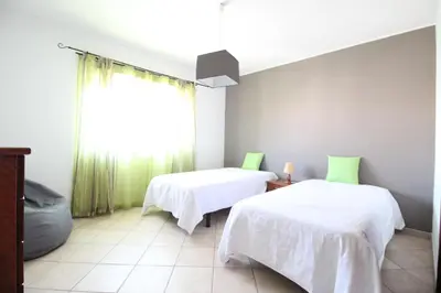 a room with two beds and a window at Dinita Apartamento nº4 in Albufeira