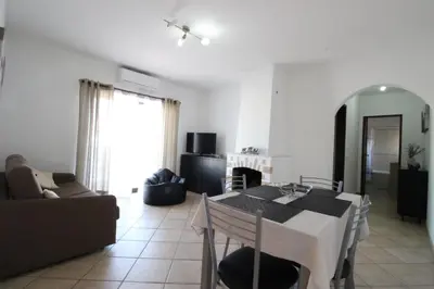 a living room with a table and a couch at Dinita Apartamento nº4 in Albufeira