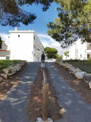 a road in front of a white building at GelbBlau Falésia in Albufeira