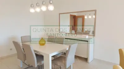 a dining room with a table and chairs and a mirror at Moradia Townhouse Vila Rosal 2 in Albufeira