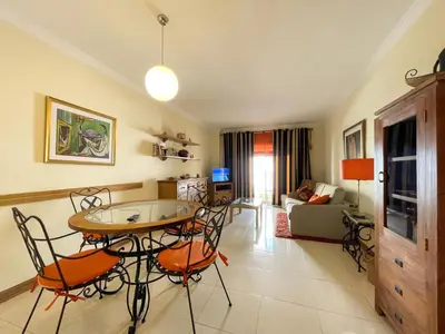 a living room with a table and chairs at Apartment Old Town Center Albufeira Walk to Beach in Albufeira
