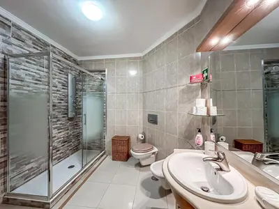 a bathroom with a shower and a sink and a toilet at Apartment Old Town Center Albufeira Walk to Beach in Albufeira