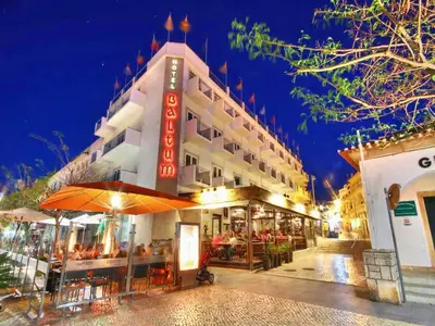 a hotel with a restaurant in front of it at night at Apartment Old Town Center Albufeira Walk to Beach in Albufeira