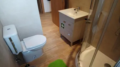 a bathroom with a toilet and a sink and a shower at 1977 in Faro