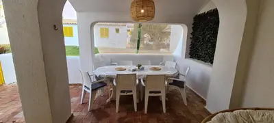 a dining room with a white table and chairs at Aldeia do Golf - Vila I4 in Vilamoura