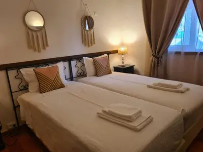 a bedroom with two beds with towels on them at Aldeia do Golf - Vila I4 in Vilamoura