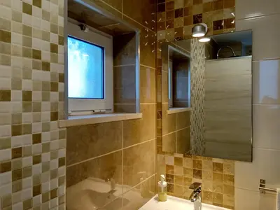 a bathroom with a tub and a window and a sink at Wonder Villa in Albufeira
