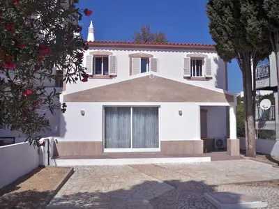 a white house with a tree in front of it at Wonder Villa in Albufeira