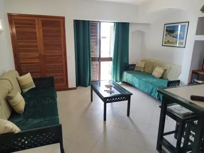 a living room with a couch and a table at Bellavista Tenis Clube A4 T1 - Albufeira INN in Albufeira