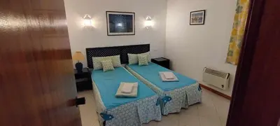 a bedroom with a bed with blue sheets and towels at Bellavista Tenis Clube A4 T1 - Albufeira INN in Albufeira