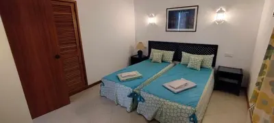 a bedroom with a bed with blue sheets and pillows at Bellavista Tenis Clube A4 T1 - Albufeira INN in Albufeira