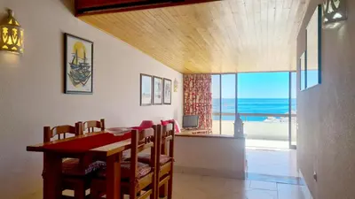 a dining room with a table and a view of the ocean at Albufeira Cerro Branco (23) in Albufeira