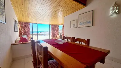a dining room with a wooden table and a large window at Albufeira Cerro Branco (23) in Albufeira